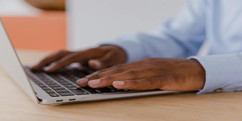 A person typing on a computer AI-generated content may be incorrect.