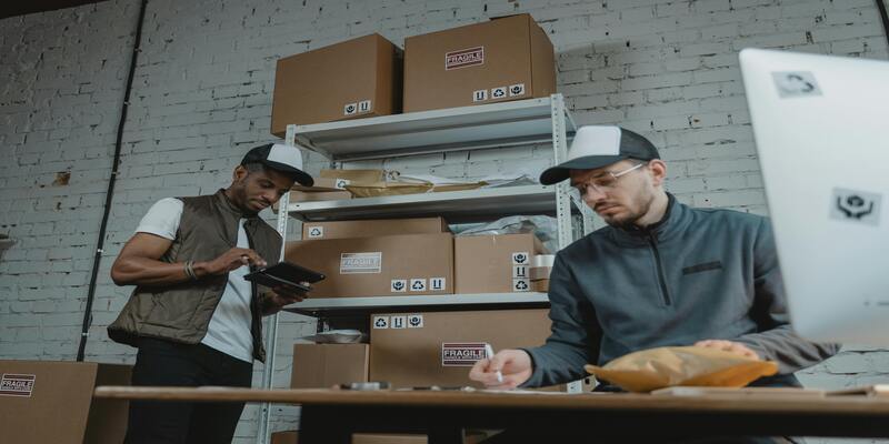 A couple of men in a warehouse AI-generated content may be incorrect.