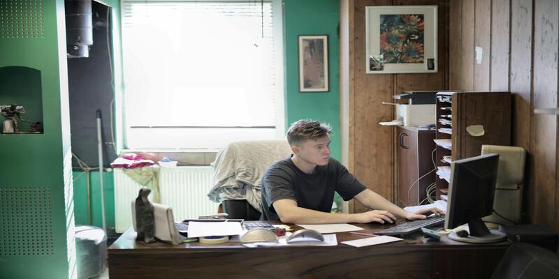A person sitting at a desk using a computer AI-generated content may be incorrect.