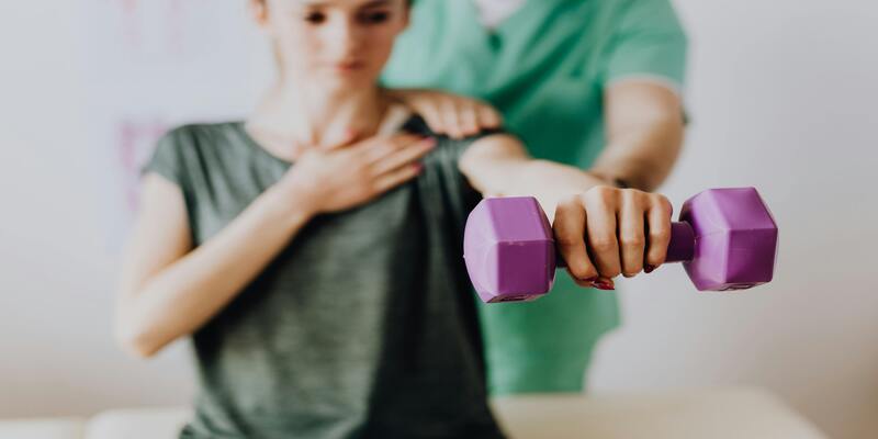 A person lifting a purple dumbbell AI-generated content may be incorrect.