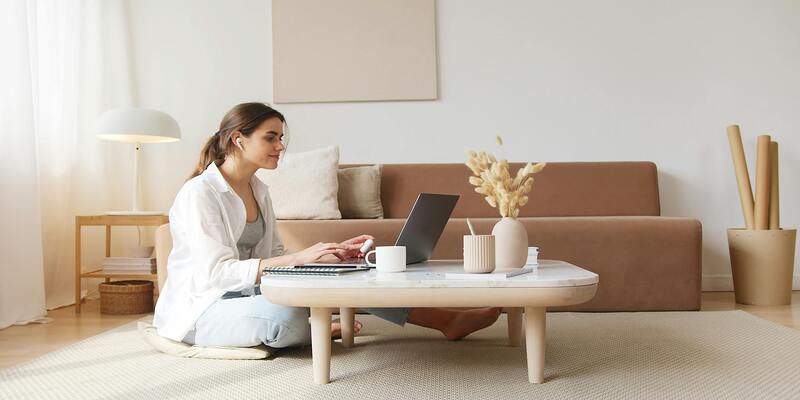 A person sitting on the floor using a computer AI-generated content may be incorrect.