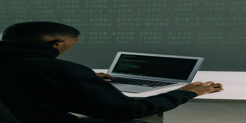 A person working on a computer AI-generated content may be incorrect.