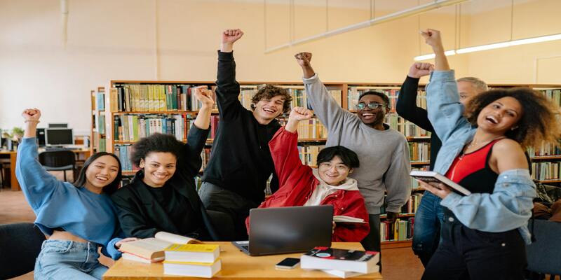 A group of people in a library AI-generated content may be incorrect.