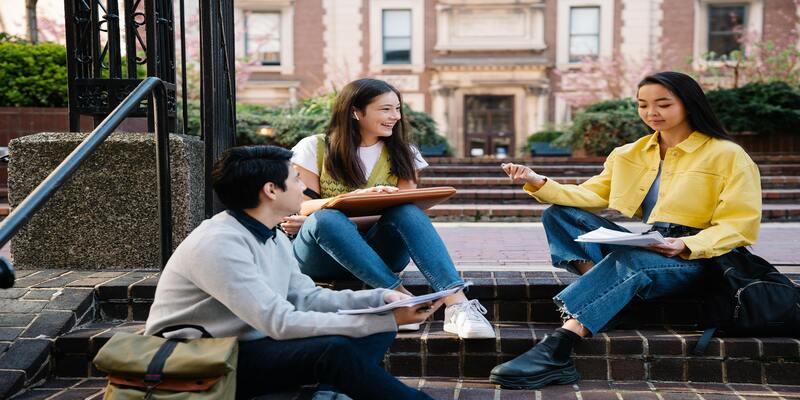 A group of people sitting on steps AI-generated content may be incorrect.