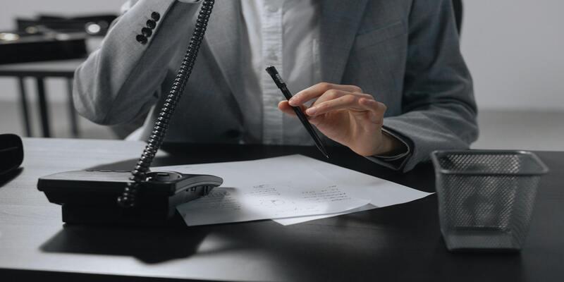 A person holding a pen AI-generated content may be incorrect.