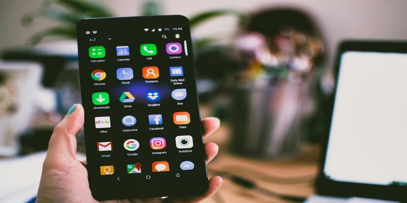A hand holding a cell phone AI-generated content may be incorrect.
