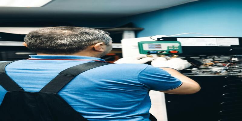 A person in a blue shirt and white gloves working on a machine AI-generated content may be incorrect.