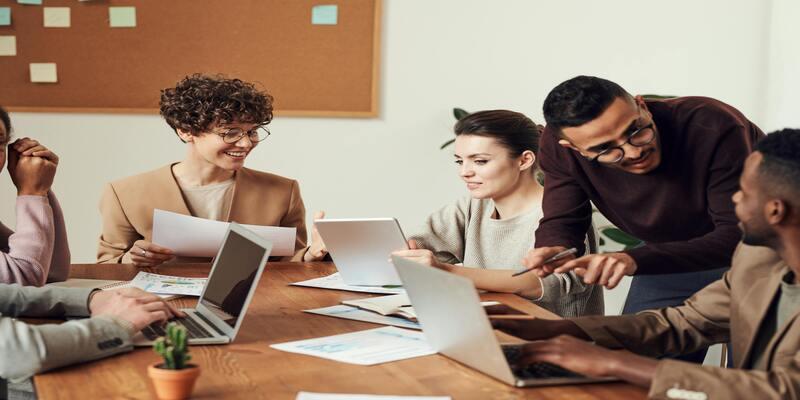 A group of people sitting around a table AI-generated content may be incorrect.