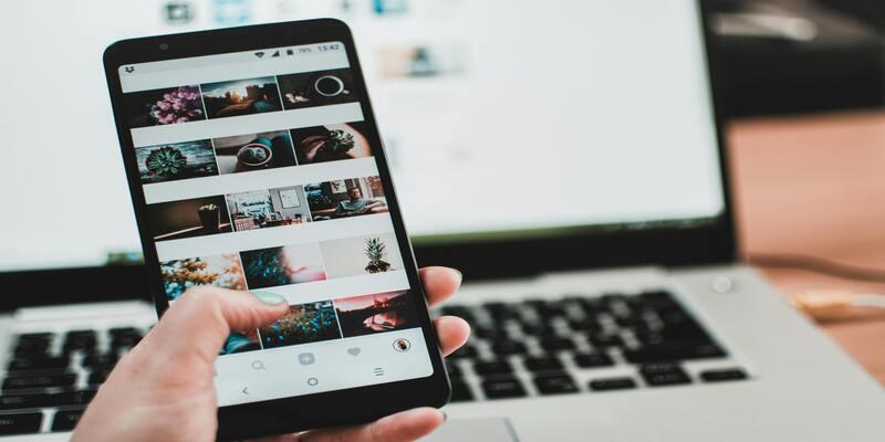 A person holding a cell phone AI-generated content may be incorrect.