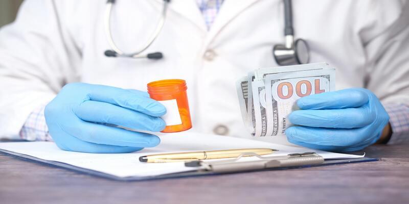 A doctor holding a pill bottle and money AI-generated content may be incorrect.